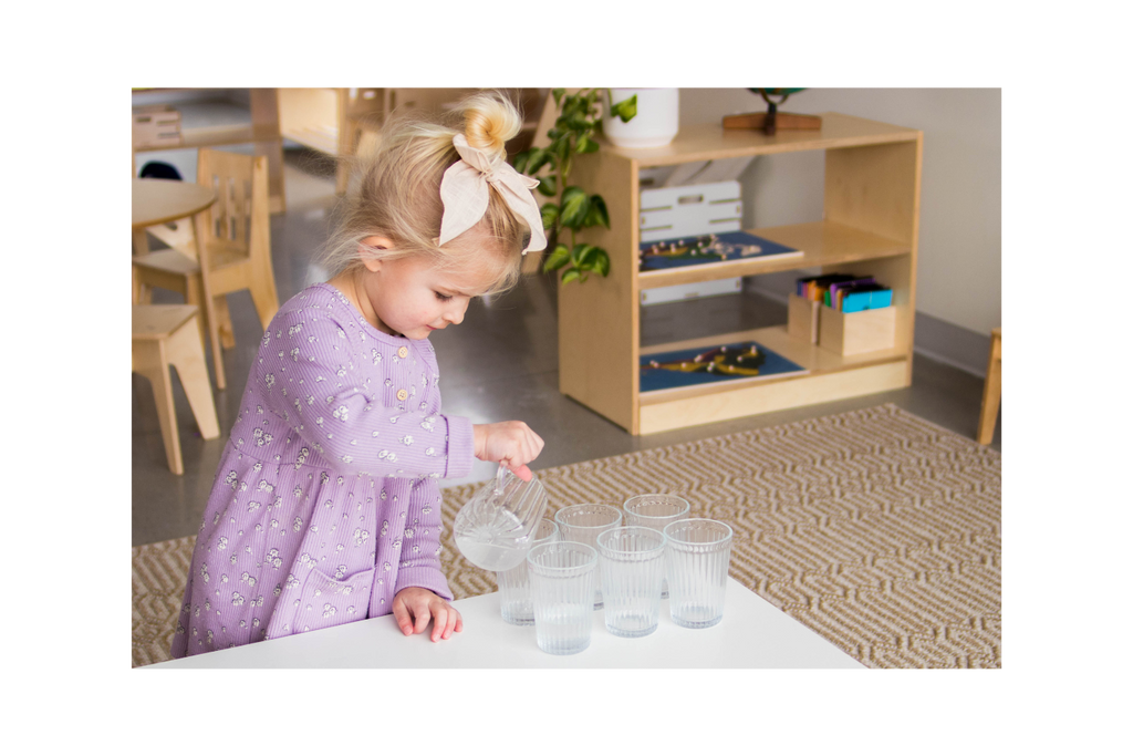Girl pouring water into glass cups