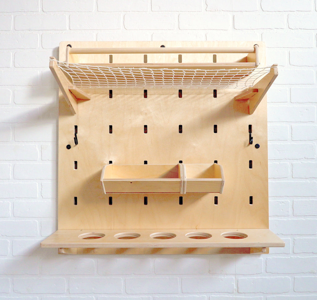 A birch pegboard designed to be used in a kitchen with a long shelf, produce hammock, storage shelves and a mason jar holder