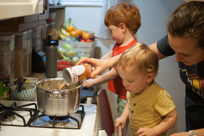 Kids cooking in a kitchen with a Toddler Tower