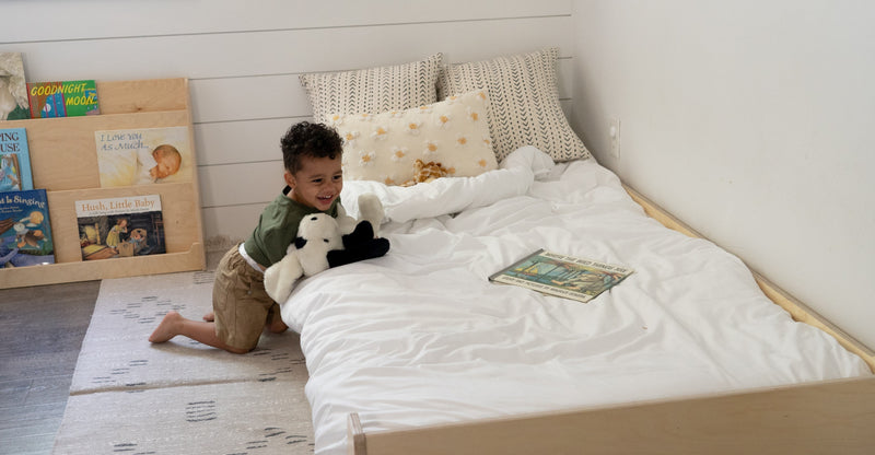 Child laying on a Montessori Floor Bed
