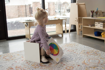 Child sitting on a Flip Chair in a Montessori Classroom