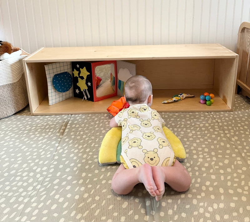 Baby in front of an infant shelf