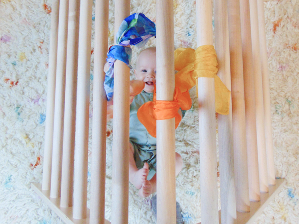 Child climbing up climbing triangle ramp
