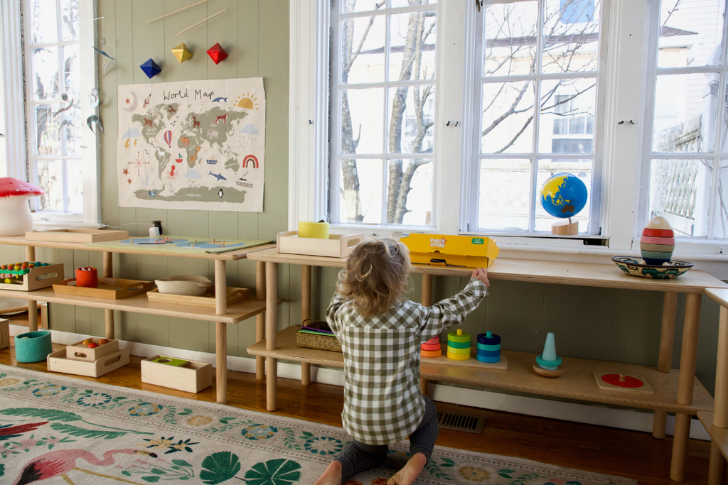 Child placing activity on modular shelves
