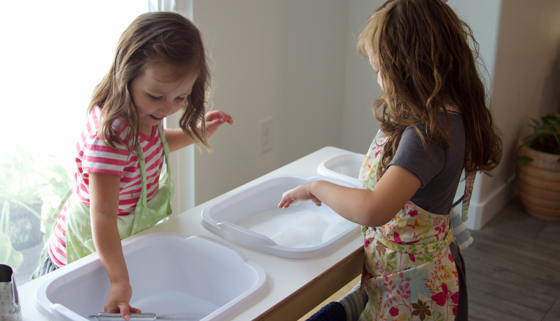 Girls washing dishes in a dishwashing station