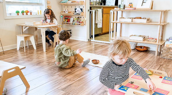 Small Children working within different workstations in a shared space