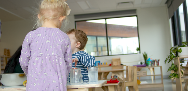 Children pouring at a Practical Life table