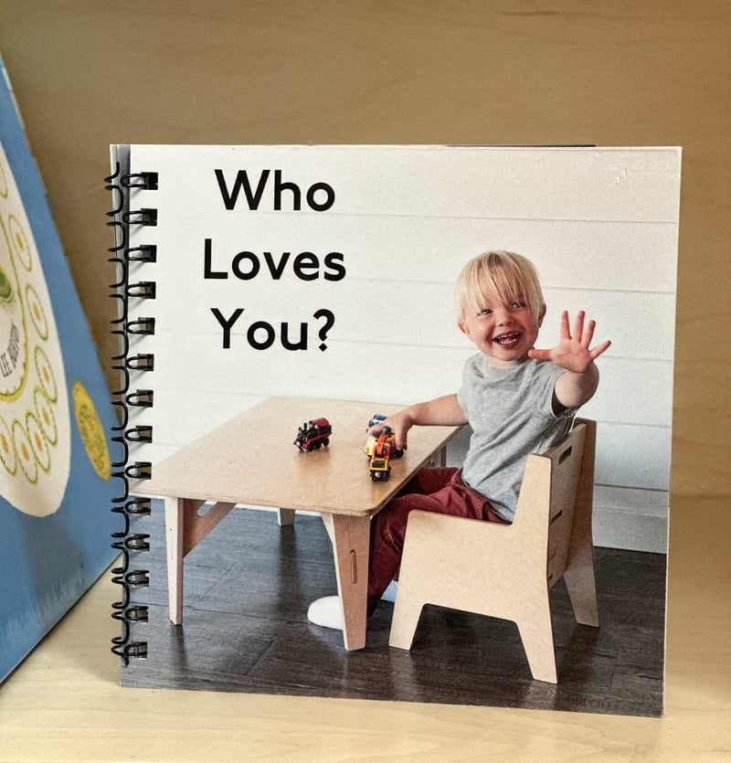 A book with a child waving on the cover