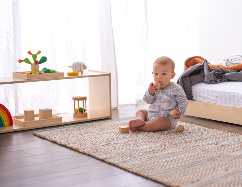 Infant next to a Floor Bed