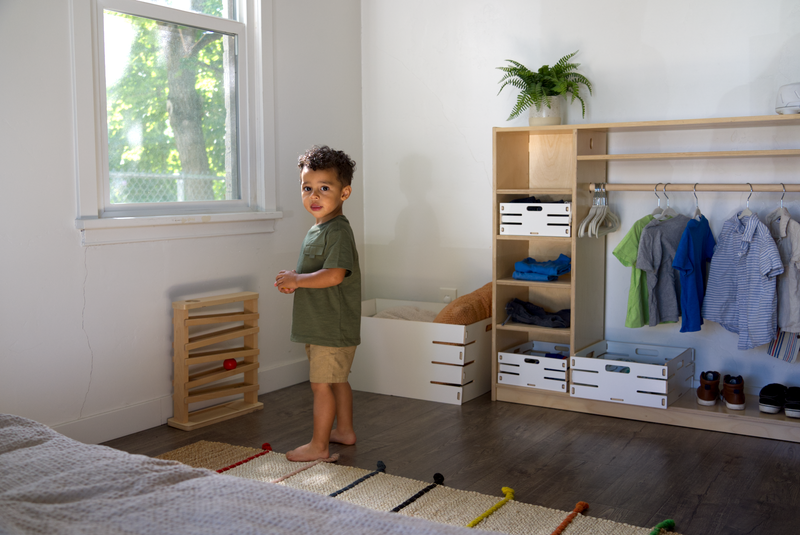 Toddler in front of a Montessori Wardrobe