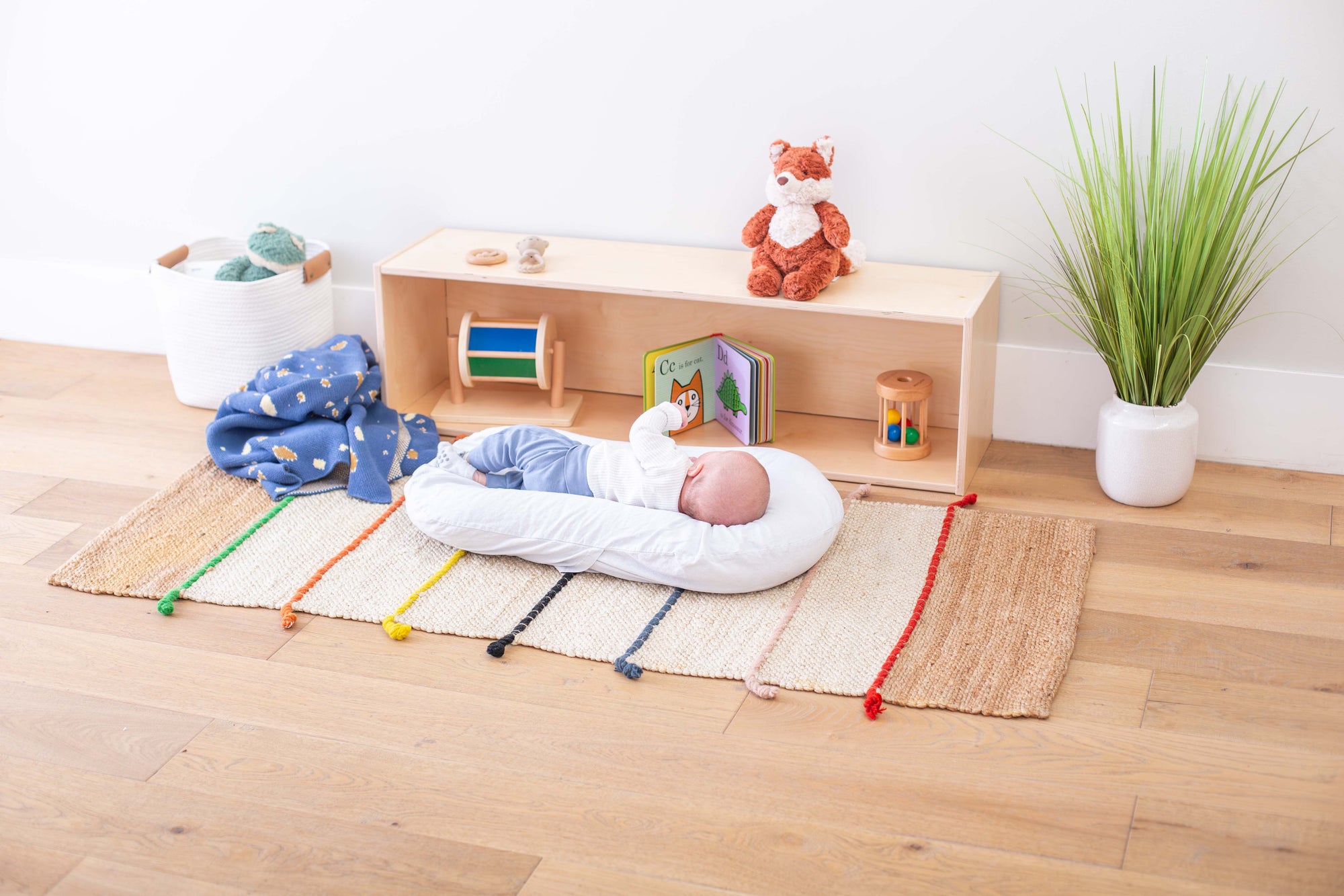 Infant in front of a prepared Infant Shelf