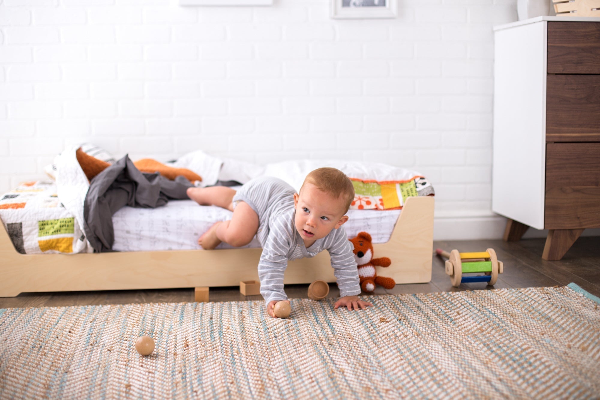 Infant crawling out of a Floor Bed
