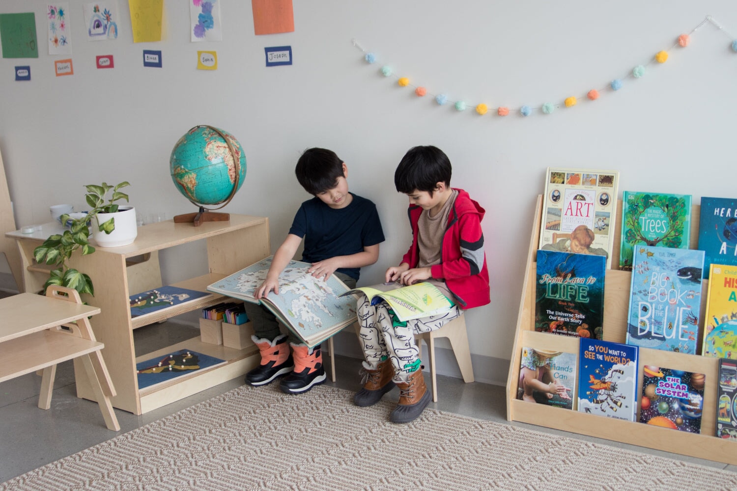Two boys reading together in  a Classroom 