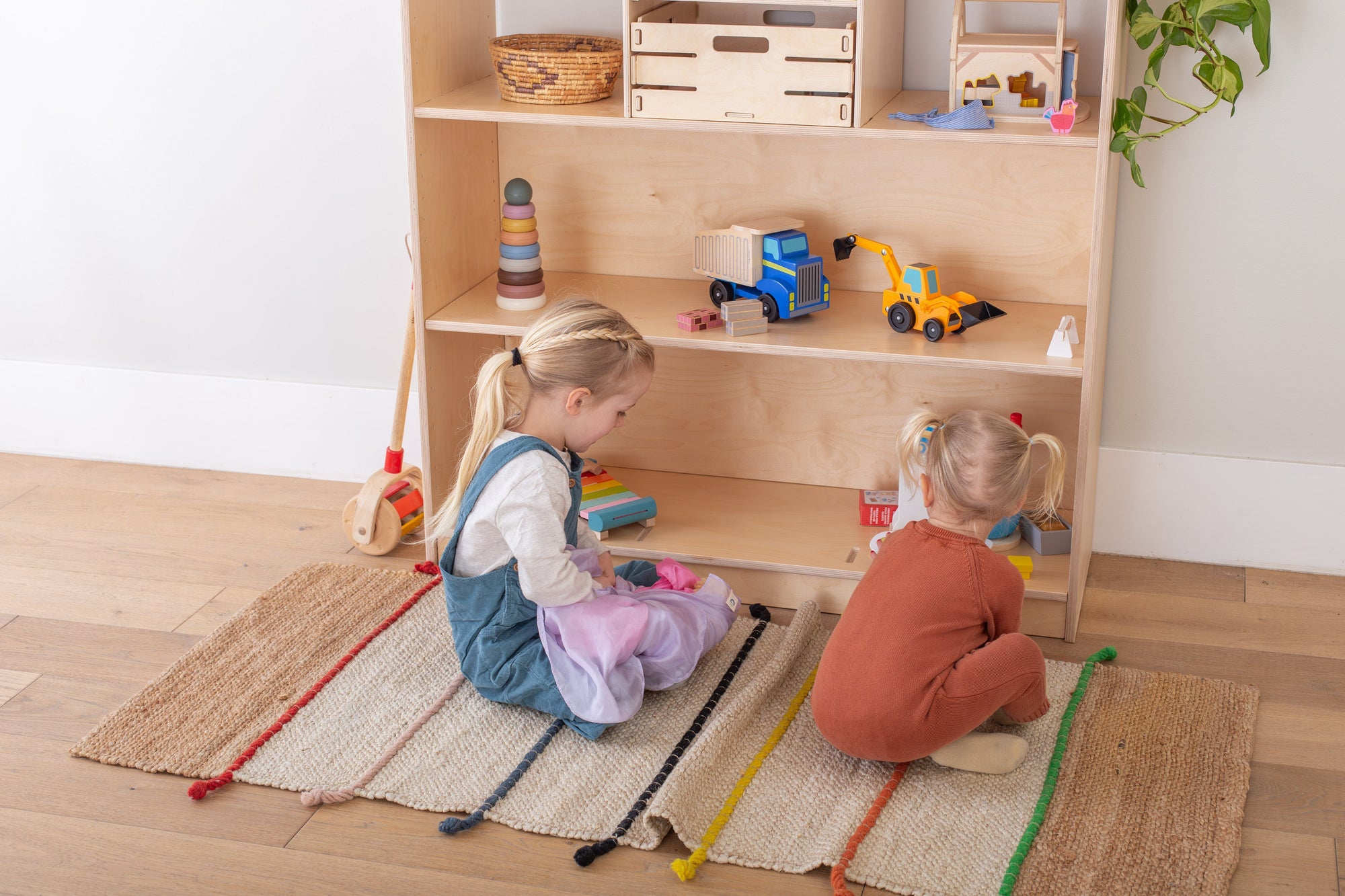 Girls playing in front of a GreenGuard certified Shelf