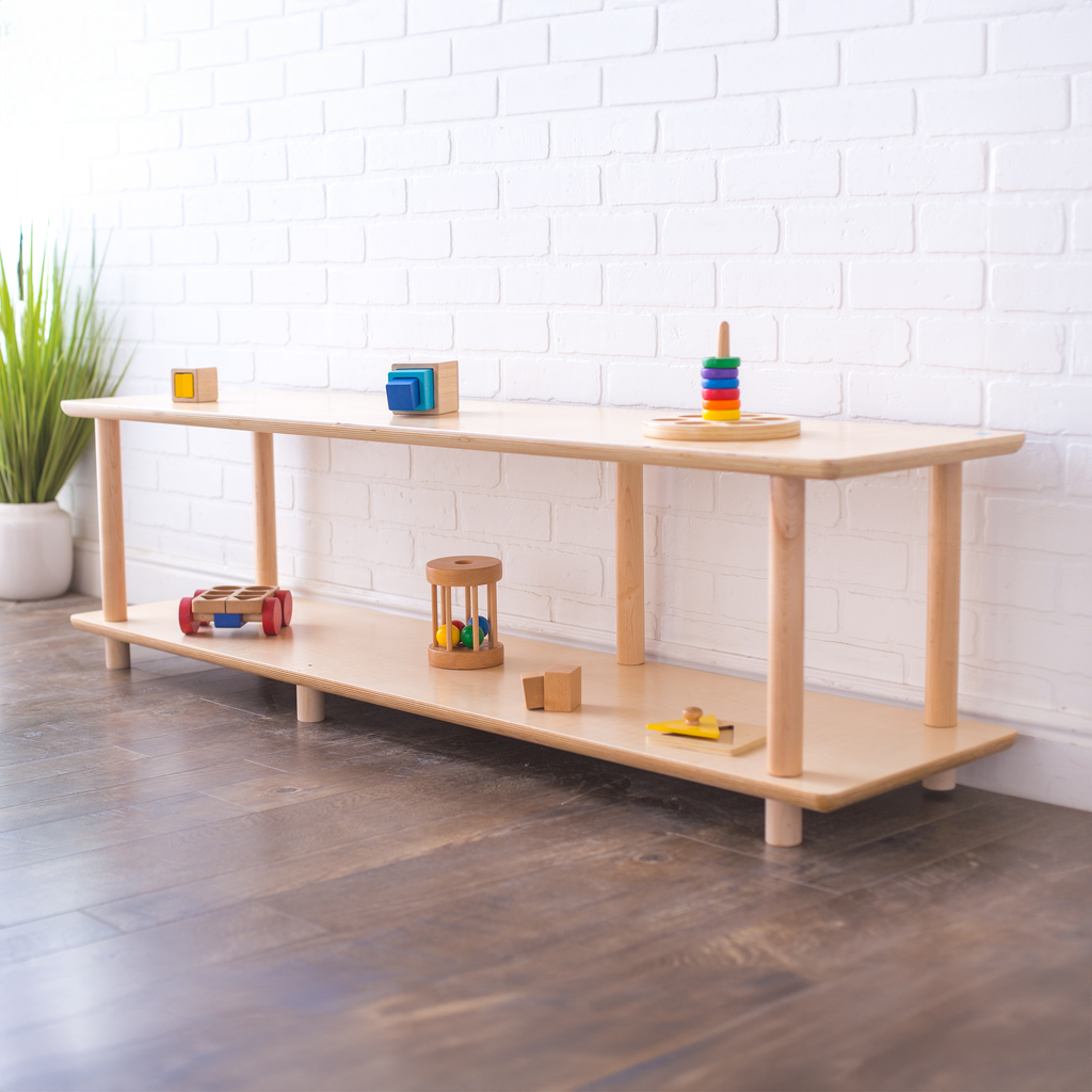 An infant shelf open shelving unit with wooden toys