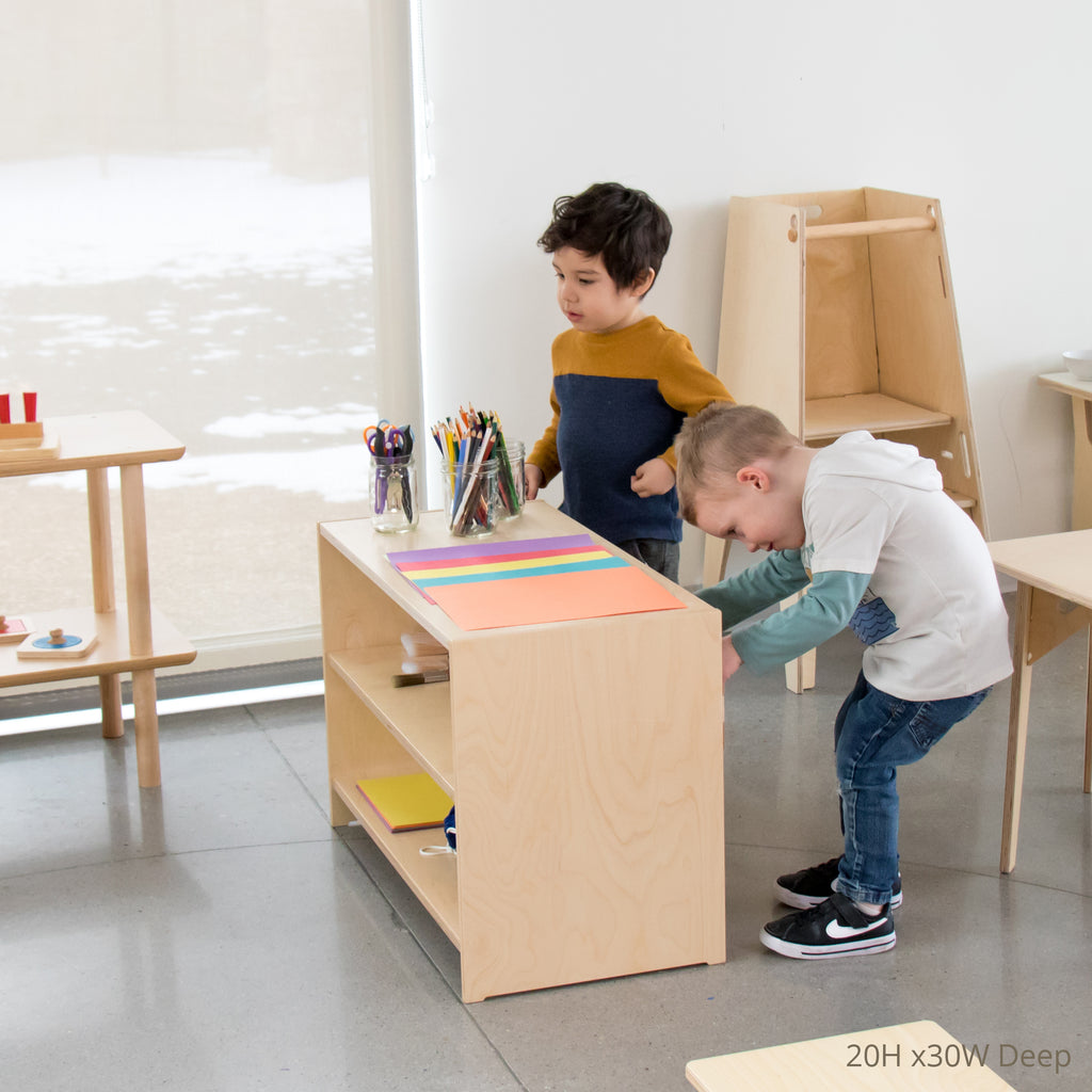 Children grabbing materials from a 20 inches high 30 inches wide deep variation of the school montessori open back shelving