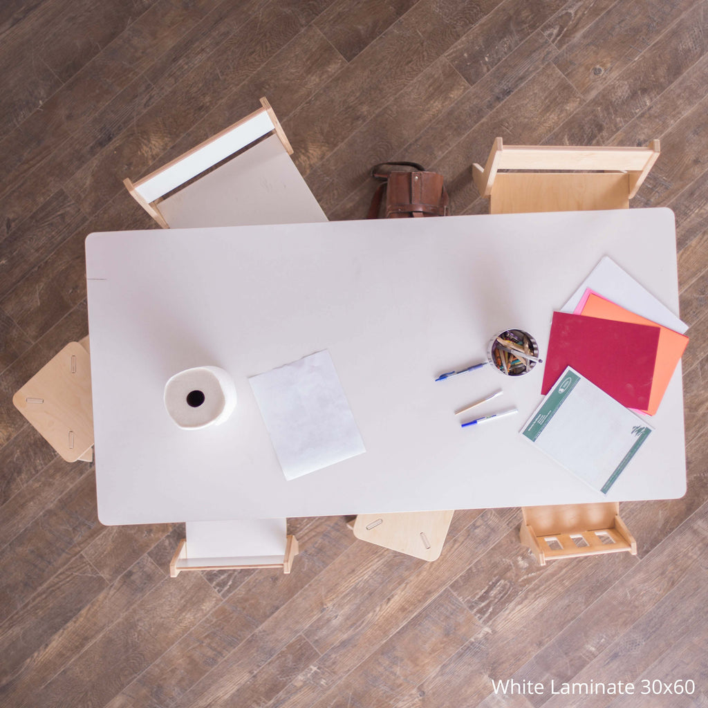 White laminate desk with office supplies on a wooden floor