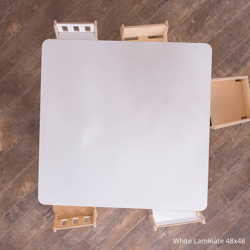 White laminate table with two chairs on a wooden floor