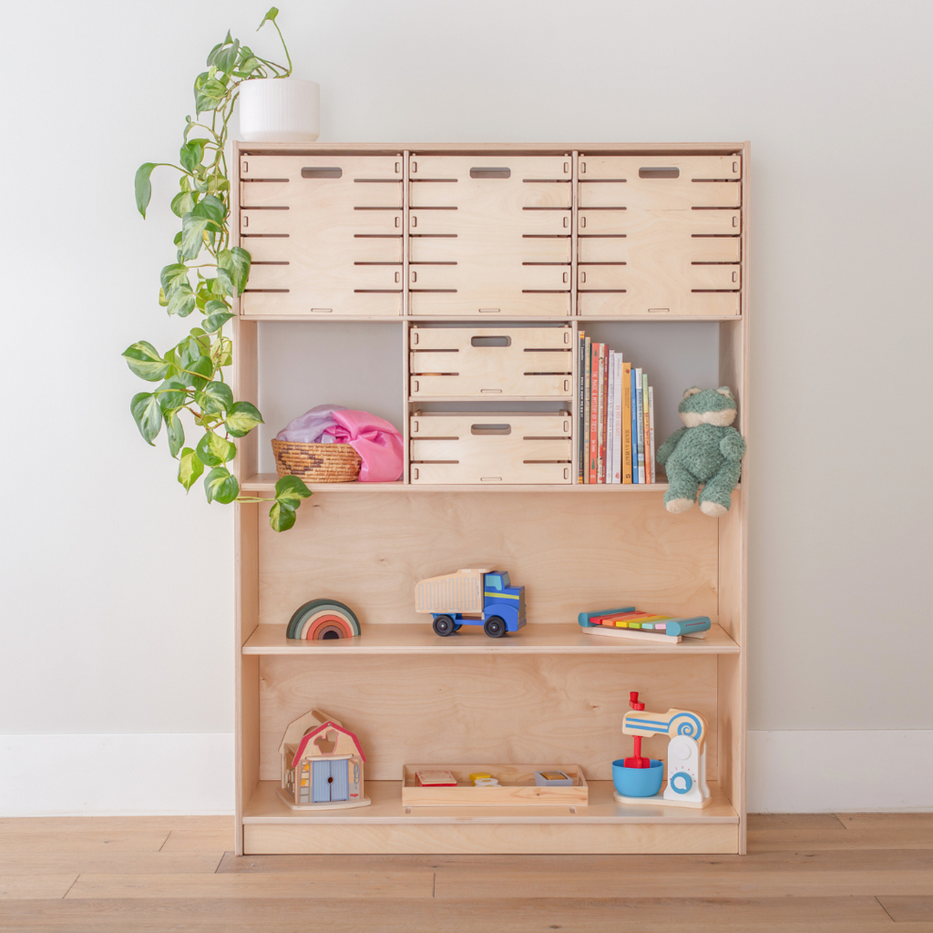 A Montessori shelf neatly organized with wooden toys and baskets for easy access.