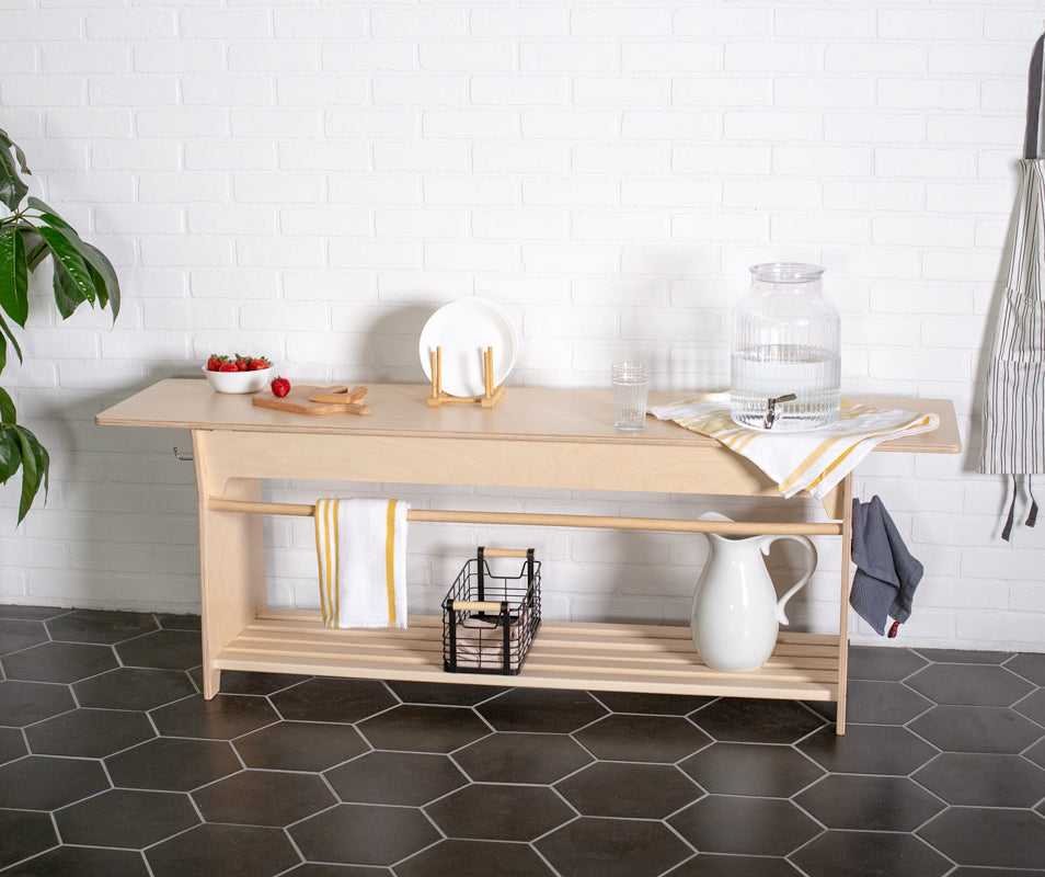 Montessori practical life table set up for a kitchen space with a pitcher and water dispenser