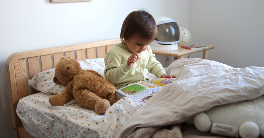 girl reading in her kids bed