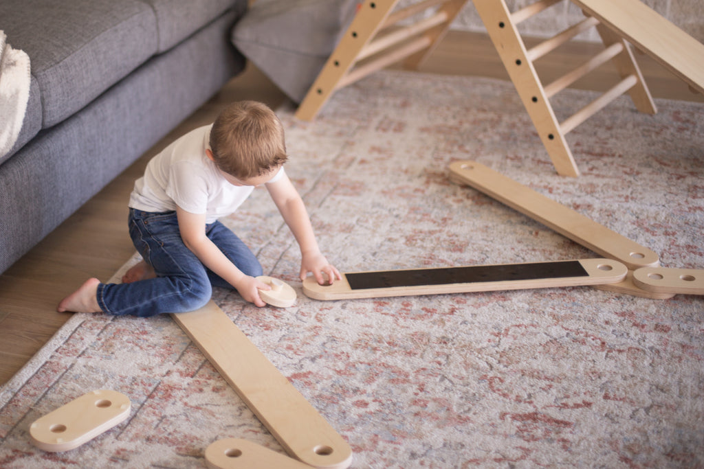 A child assembling balance beams in their home.