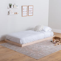 Simple bedroom with a wooden platform bed, white bedding, and minimal decor.
