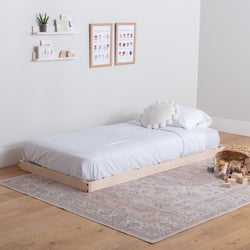 Simple bedroom with a wooden platform bed, white bedding, and minimal decor.