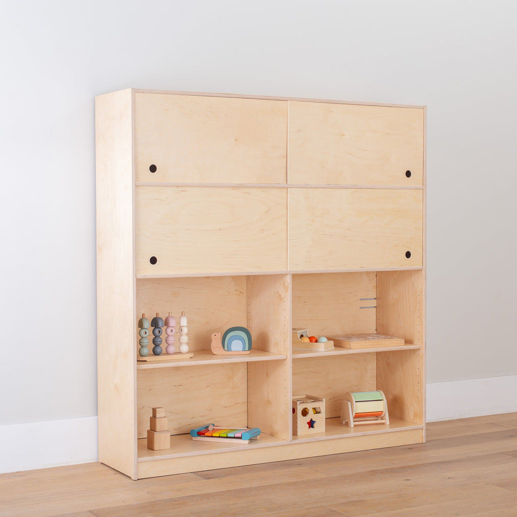 toy rotation shelf with 4 sliding doors and a divider with toys displayed