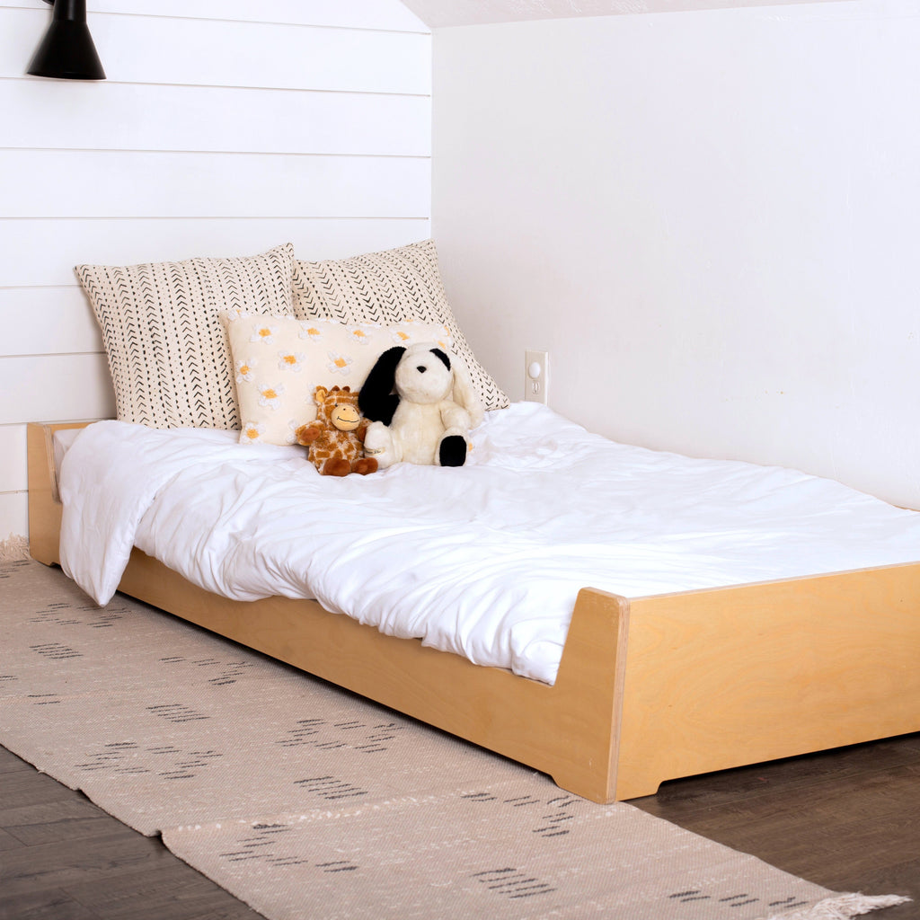Toddler Floor Bed with White Bedding in a Montessori Bedfroom