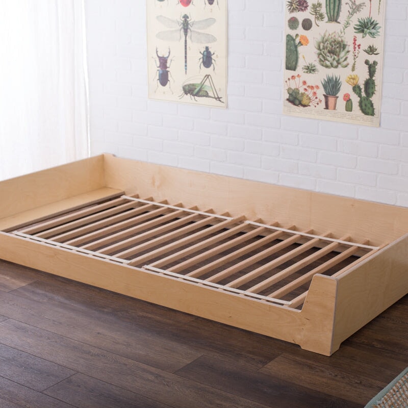 Wooden Floor Bed on a wooden floor with wall art in the background