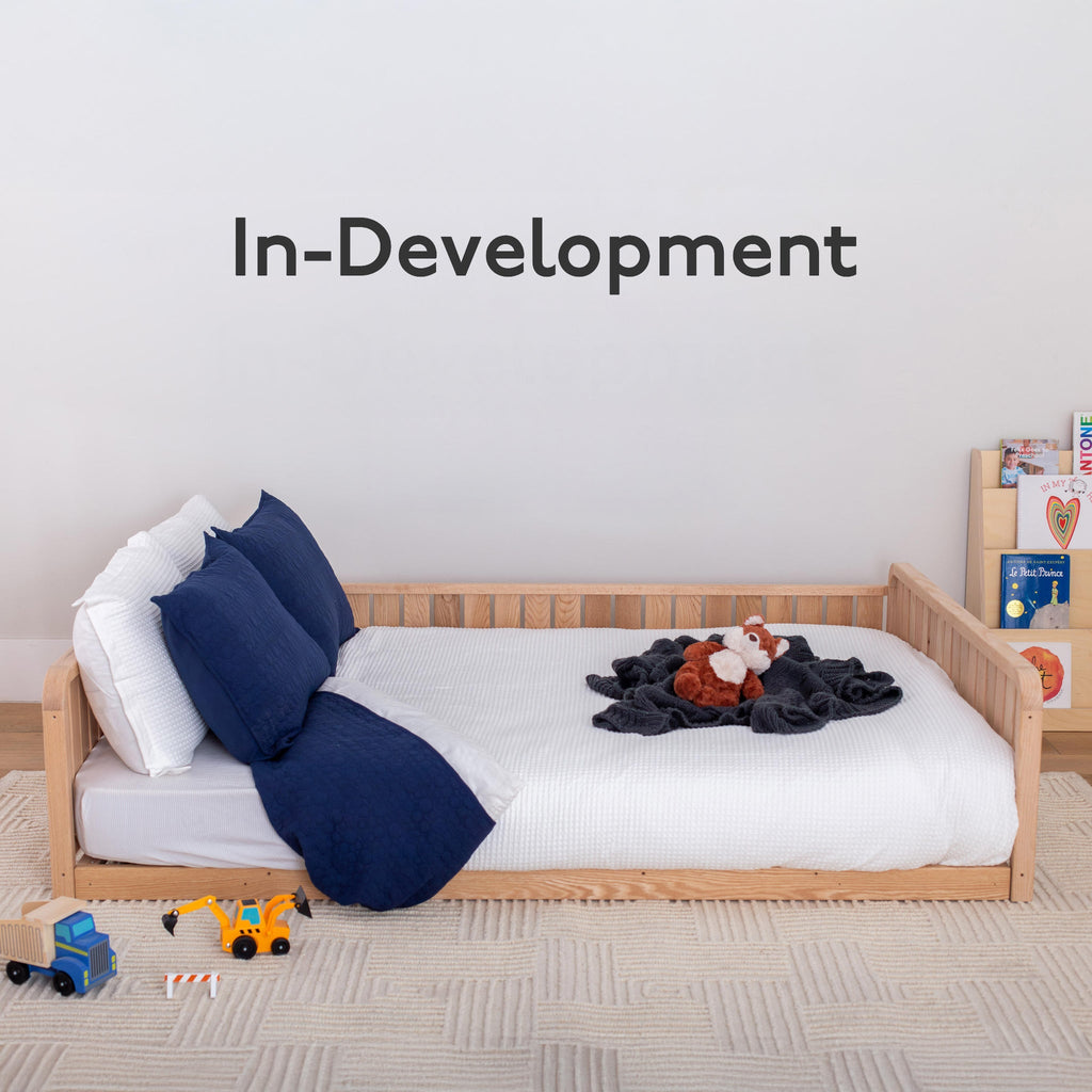 In development listing with a full size floor bed with partial rails
