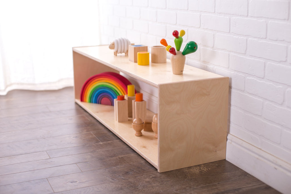Long birch montessori infant shelf with rainbow toys on top