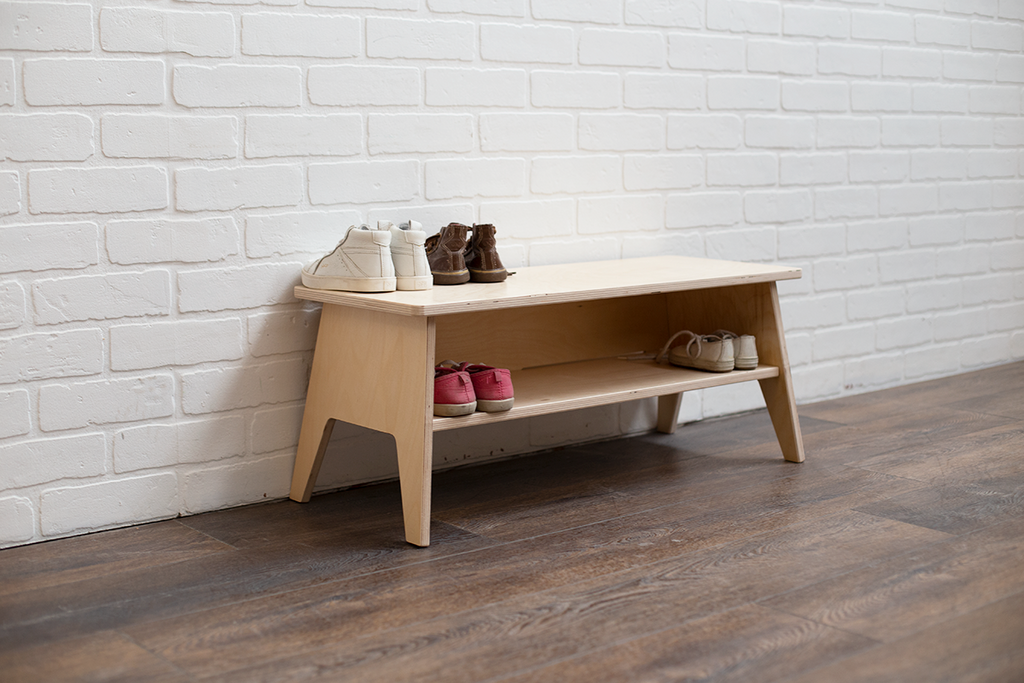 Small shoe bench functioning as shoe storage for a few pairs of shoes