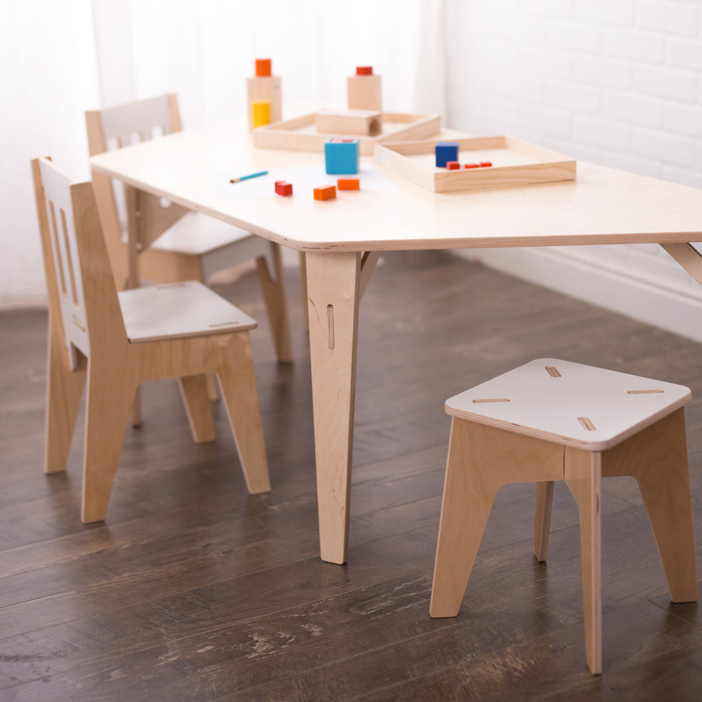 Trapezoid table with two kid's chairs and one kid's stool.