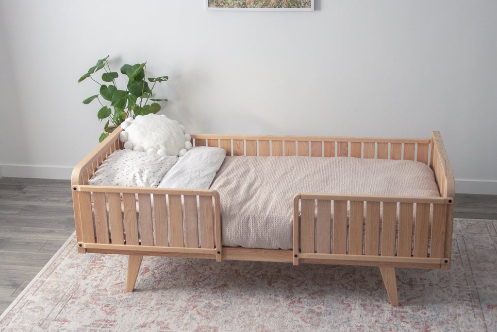 The twin oak bed frame with two headboards, a full side board, legs, and two 1/3 rails