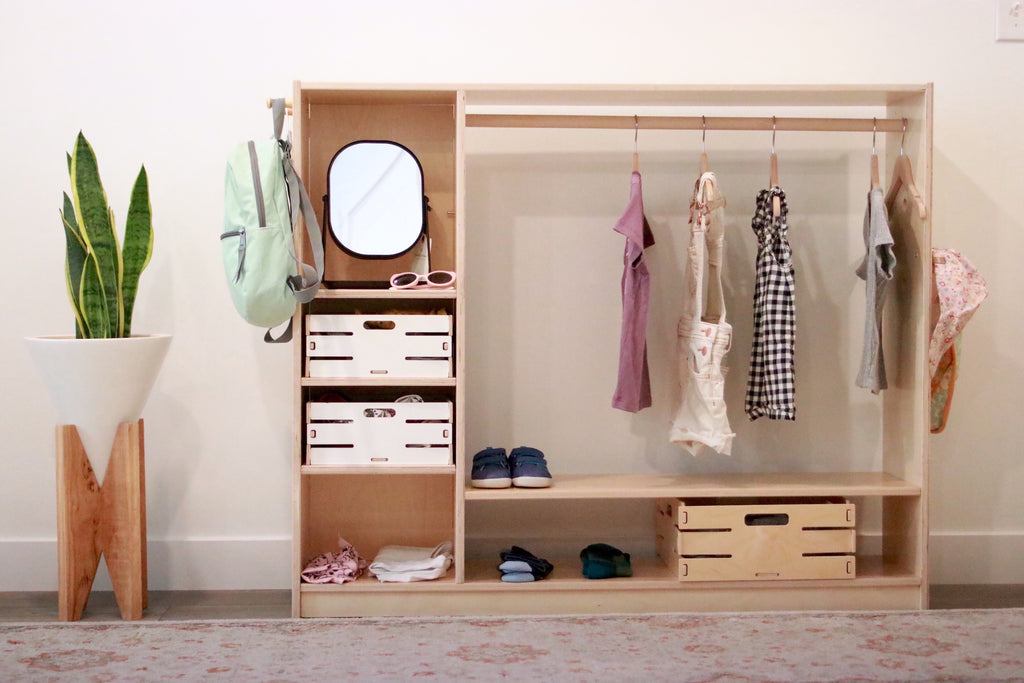 wide wardrobe with various baskets and a mirror
